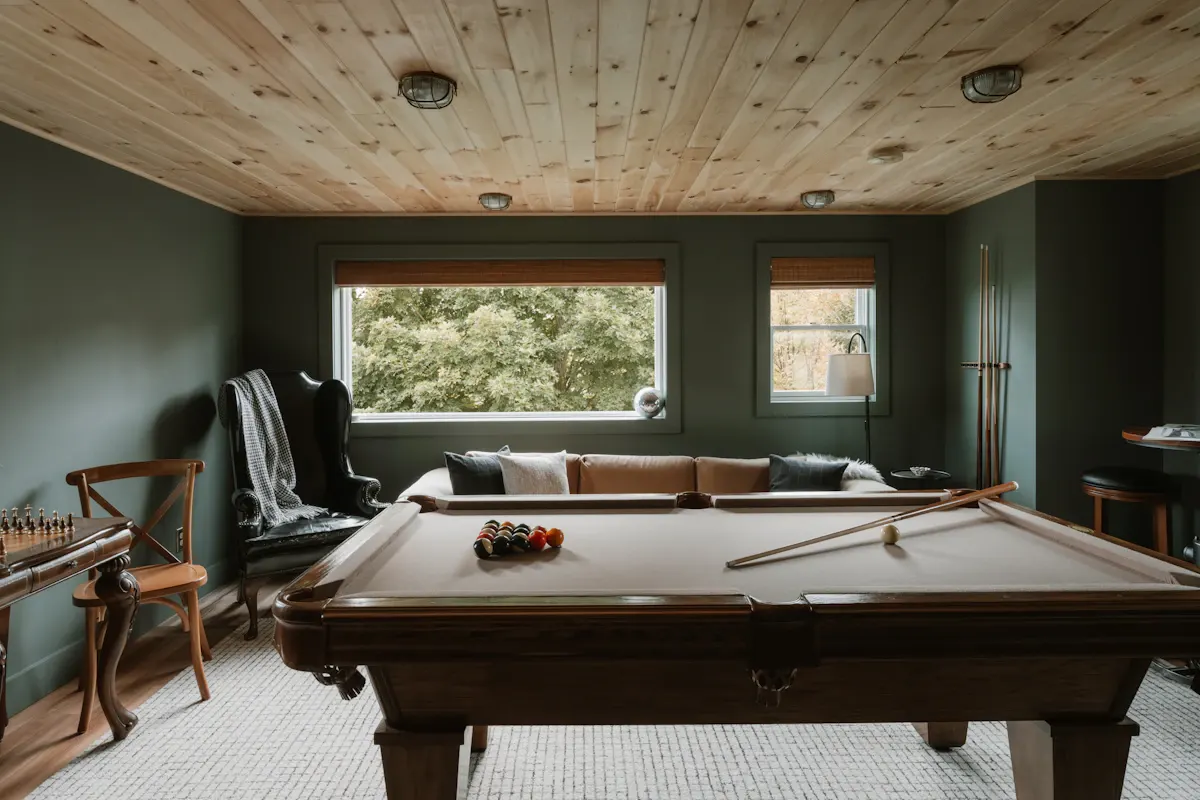 Basement recreation room with a pool table
