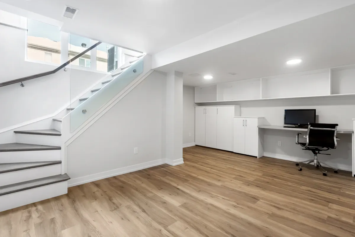 Basement workspace beside a white stair