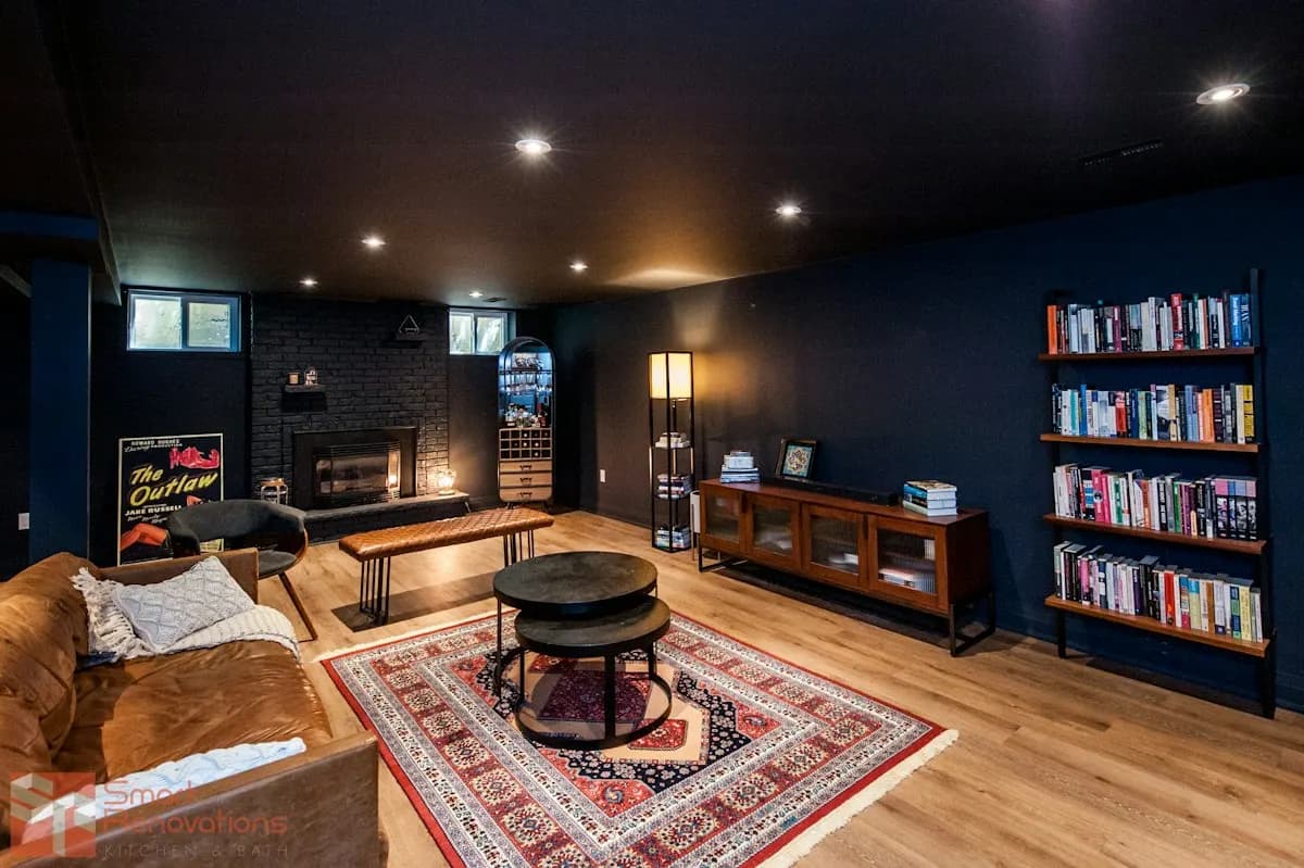 Basement media room with bookcases, sofa and recessed lighting
